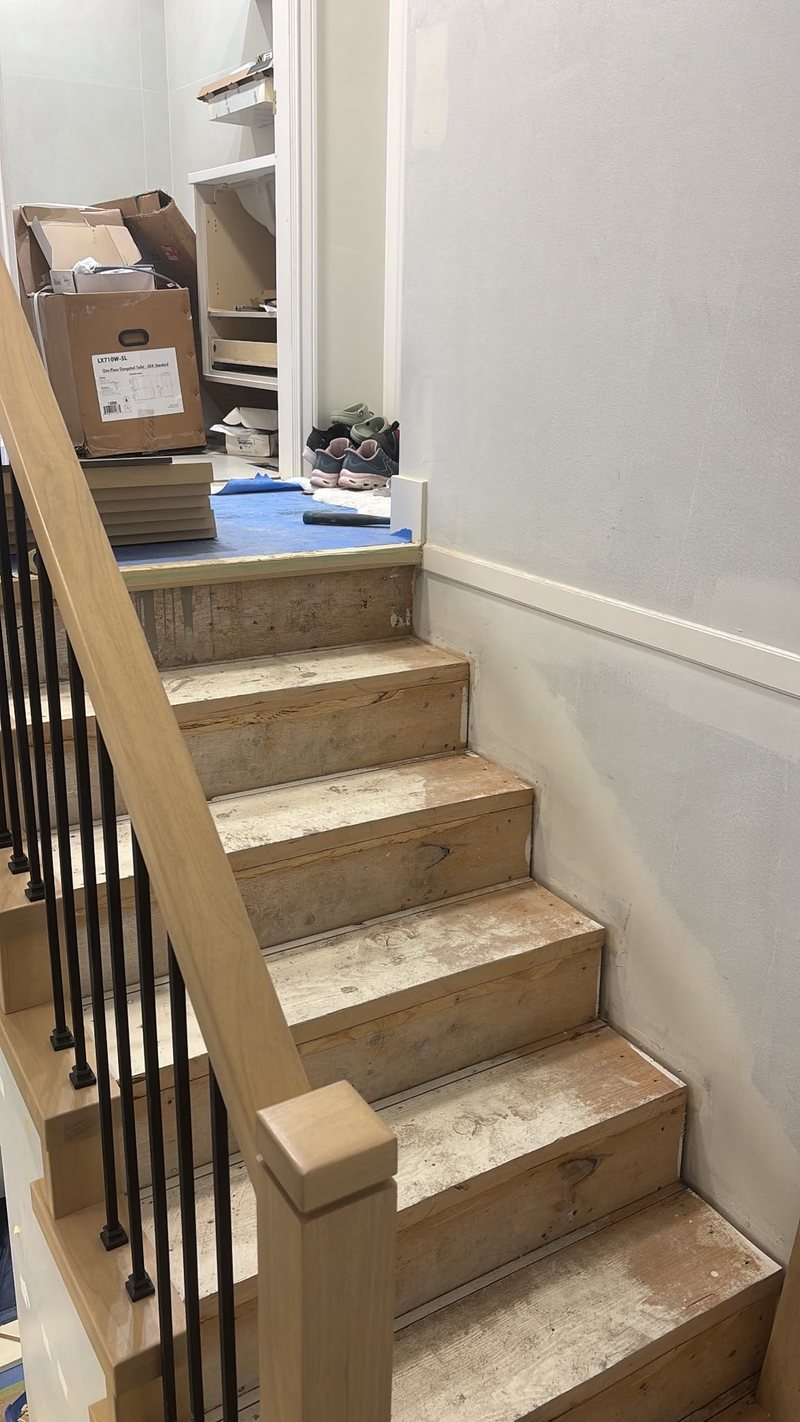New treads installed with floors protected during the stair job, Surrey