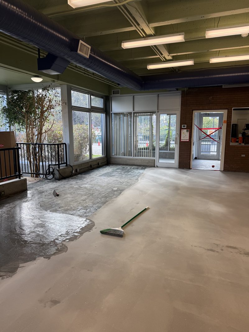 Concrete being skim-coated before rubber flooring, Victoria
