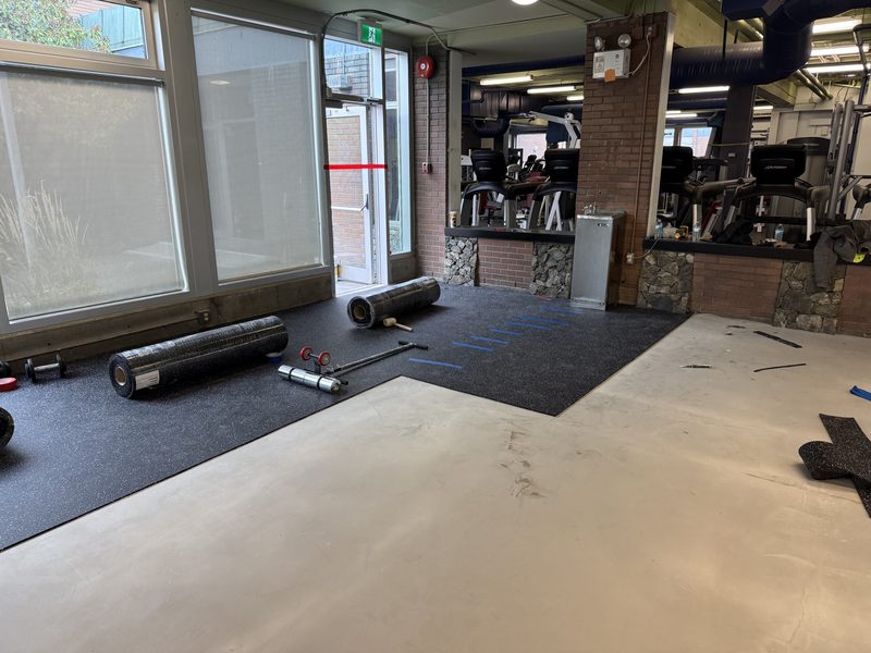 First rubber gym flooring rolls going down over the prepared concrete, Victoria